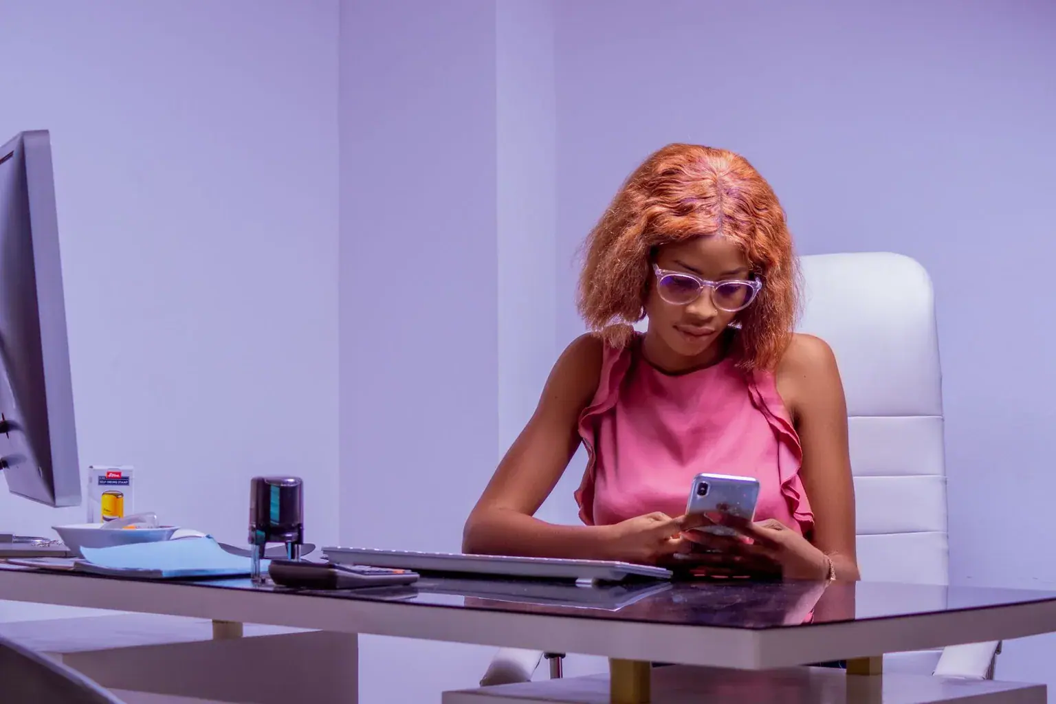 A woman checking her phone at work