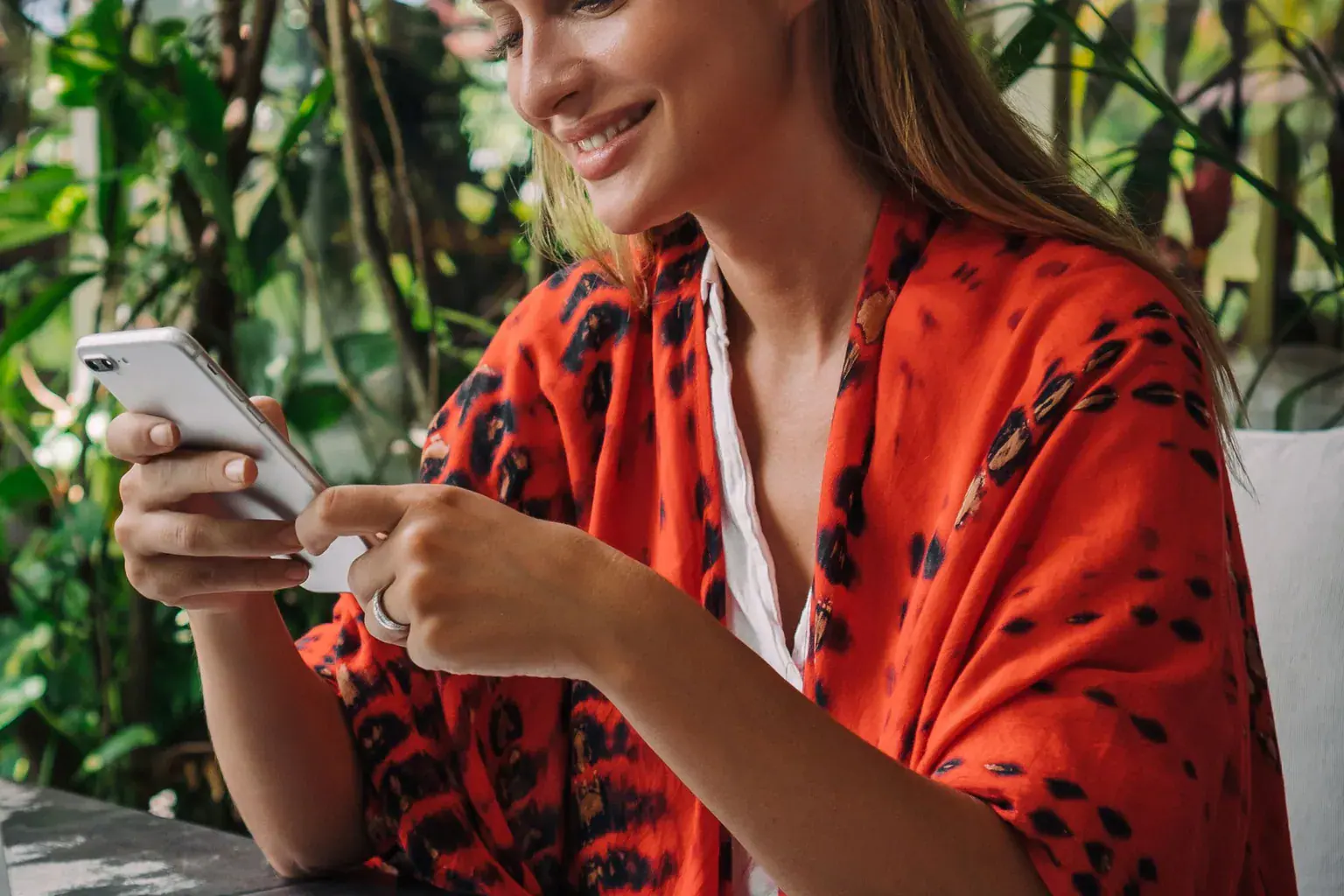 A woman checking her phone over coffee